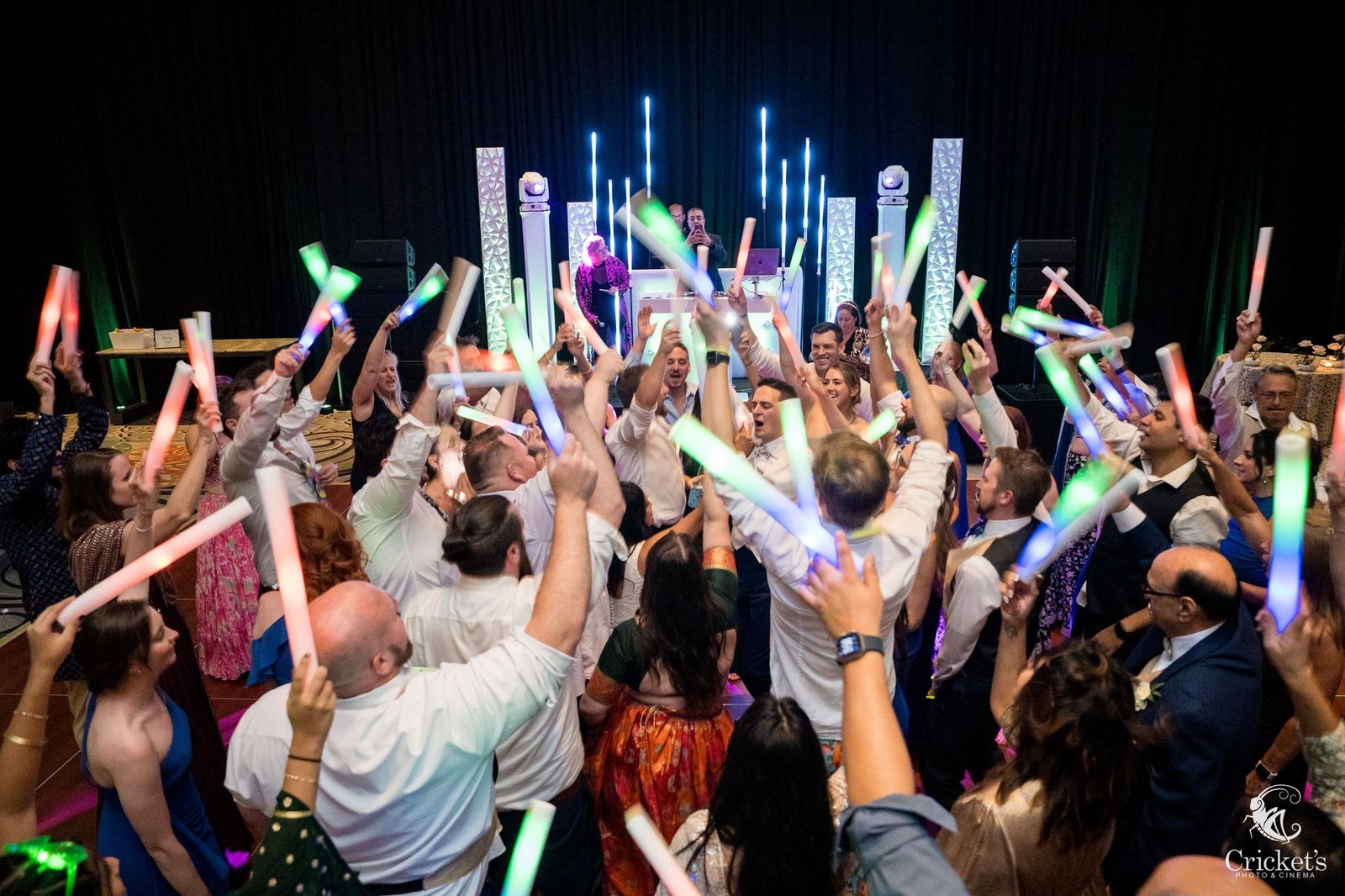 Wedding guests dancing on a packed dance floor